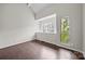 Well-lit bedroom with hardwood floors and large windows, providing ample natural light at 415 W 7Th St # H, Charlotte, NC 28202