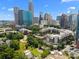 A high-level view of an apartment community, tree canopy, and city skyline, showcasing a central location at 415 W 7Th St # H, Charlotte, NC 28202