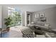 Staged living room with large windows and modern decor at 415 W 7Th St # H, Charlotte, NC 28202