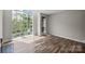 Sunlit living room featuring hardwood floors and a large window at 415 W 7Th St # H, Charlotte, NC 28202