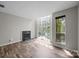 Unfurnished living room featuring a fireplace and large window at 415 W 7Th St # H, Charlotte, NC 28202