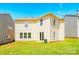 Home's spacious backyard with green grass and a view of the back exterior at 4521 Palustris Ct, Charlotte, NC 28269