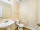 A half bathroom includes tiled flooring, a white sink and toilet, and a large mirror for added convenience at 4521 Palustris Ct, Charlotte, NC 28269