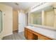 A bathroom features hardwood flooring, a single vanity, and a shower with glass doors for a clean and modern look at 4521 Palustris Ct, Charlotte, NC 28269