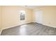 Cozy bedroom featuring modern gray vinyl floors, light yellow walls, and a closet at 4521 Palustris Ct, Charlotte, NC 28269