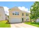 Charming two-story home with light yellow siding, white trim, attached garage, and a lush lawn at 4521 Palustris Ct, Charlotte, NC 28269
