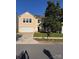 Inviting two-story home featuring a well-kept lawn, mature tree, and a convenient two-car garage at 4521 Palustris Ct, Charlotte, NC 28269