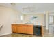Well-lit kitchen features a double sink, oak cabinetry, and a black dishwasher for convenient meal prep and cleanup at 4521 Palustris Ct, Charlotte, NC 28269
