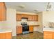Kitchen with wood cabinets, laminate countertops, ceramic tile floors, and stainless steel range at 4521 Palustris Ct, Charlotte, NC 28269