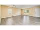 A large living room features hardwood flooring, multiple windows, and a white door for a bright and spacious feel at 4521 Palustris Ct, Charlotte, NC 28269