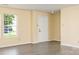 Open concept living room with gray wood-look floors, neutral walls, and an entry door at 4521 Palustris Ct, Charlotte, NC 28269