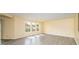 Large living room with gray wood-look floors, neutral walls, and multiple windows at 4521 Palustris Ct, Charlotte, NC 28269