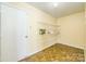 A storage room features tiled flooring, wire shelving, and a white door for ample storage and organization at 4521 Palustris Ct, Charlotte, NC 28269