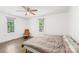 Spacious bedroom featuring hardwood floors, two windows, and a comfortable chair with ottoman at 485 Lincoln St, Cramerton, NC 28032