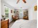Bright bedroom featuring hardwood floors, a large window, and vintage decor with a ceiling fan for added comfort at 485 Lincoln St, Cramerton, NC 28032