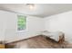 Bright bedroom features wood floors, a single bed frame, and lots of natural light at 485 Lincoln St, Cramerton, NC 28032