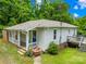 View of exterior and back deck of the home with lush greenery at 485 Lincoln St, Cramerton, NC 28032