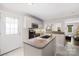 Kitchen features an island with tile floor, ample cabinets, and stainless steel appliances at 485 Lincoln St, Cramerton, NC 28032