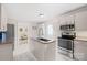 Bright kitchen featuring an island, stainless steel appliances and white cabinets at 485 Lincoln St, Cramerton, NC 28032