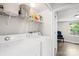Laundry room featuring a washer, dryer, and storage space with hardwood floors at 485 Lincoln St, Cramerton, NC 28032