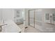 Modern bathroom featuring double sink vanity, a glass-enclosed shower, and a view of the main bedroom at 577 Nesbe St # 2222, Lancaster, SC 29720