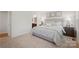 Serene main bedroom featuring plush carpeting, neutral décor, and a view of the ensuite bathroom at 577 Nesbe St # 2222, Lancaster, SC 29720