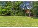 Sprawling backyard lawn with mature trees providing privacy and shade at 6211 Cruden Bay Way, Charlotte, NC 28277