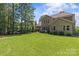 Expansive backyard featuring a patio and lush green lawn at 6211 Cruden Bay Way, Charlotte, NC 28277