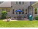 Backyard featuring patio with seating and a grill, with grass lawn surrounded by lush greenery at 6211 Cruden Bay Way, Charlotte, NC 28277