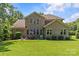 Spacious backyard showcasing an expansive lawn and outdoor seating area at 6211 Cruden Bay Way, Charlotte, NC 28277
