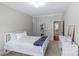 Bright bedroom with white furniture, a bed, and an open door leading to another room at 6211 Cruden Bay Way, Charlotte, NC 28277