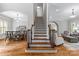 Grand foyer with hardwood floors, staircase, and views into the dining and living areas at 6211 Cruden Bay Way, Charlotte, NC 28277