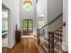Grand foyer boasts hardwood floors, high ceilings, a staircase, and a view of the front door at 6211 Cruden Bay Way, Charlotte, NC 28277