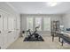 Bright home gym with large windows, stationary bike, and desk area for working out at 6211 Cruden Bay Way, Charlotte, NC 28277
