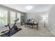 Spacious home gym with large windows and exercise equipment, including a stationary bike at 6211 Cruden Bay Way, Charlotte, NC 28277
