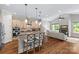 Open kitchen with an island bar overlooking the living area, creating a connected living space at 6211 Cruden Bay Way, Charlotte, NC 28277