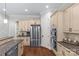 Kitchen showcasing stainless steel refrigerator and oven, granite countertops and ample cabinet space at 6211 Cruden Bay Way, Charlotte, NC 28277