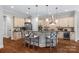 Stylish kitchen with a central island, stainless steel appliances, granite counters, and hardwood floors at 6211 Cruden Bay Way, Charlotte, NC 28277