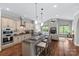 Modern kitchen featuring a spacious island, stainless appliances, hardwood floors, and an open layout to the living room at 6211 Cruden Bay Way, Charlotte, NC 28277
