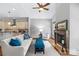 Bright living room showcases kitchen access, a fireplace, and comfortable seating at 6211 Cruden Bay Way, Charlotte, NC 28277