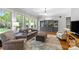 Inviting living room with large windows, hardwood floors, a cozy seating area, and stylish built-in cabinetry at 6211 Cruden Bay Way, Charlotte, NC 28277