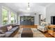 Bright living room featuring hardwood floors, neutral décor, and stylish built-in cabinetry at 6211 Cruden Bay Way, Charlotte, NC 28277