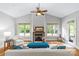 Bright living room featuring a fireplace, high ceilings, and natural light from large windows at 6211 Cruden Bay Way, Charlotte, NC 28277