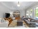 Open living space with hardwood floors, a comfortable seating arrangement, and easy access to the kitchen at 6211 Cruden Bay Way, Charlotte, NC 28277