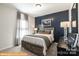 Cozy bedroom featuring a dark accent wall, comfortable bedding, and soft carpeting at 6336 Busch Ave, Midland, NC 28107