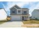 Charming two-story home showcasing traditional architecture and a well-manicured front lawn at 6336 Busch Ave, Midland, NC 28107