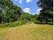 Spacious backyard filled with trees, offering shade and privacy at 647 Mckay Hill Rd, Mount Gilead, NC 27306