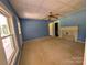 Blue bedroom features a fireplace and a large window providing natural light at 647 Mckay Hill Rd, Mount Gilead, NC 27306