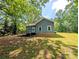 View of home featuring wood deck and yard shaded by mature trees at 647 Mckay Hill Rd, Mount Gilead, NC 27306