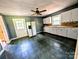 Functional kitchen with white cabinets, laminate countertops, and checkered tile flooring at 647 Mckay Hill Rd, Mount Gilead, NC 27306